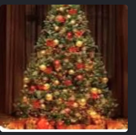 Decorated Christmas tree with red and gold ornaments in front of curtains