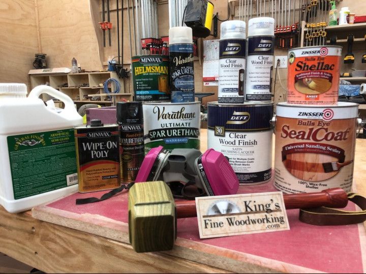 A king 's fine woodworking sign sits on a table