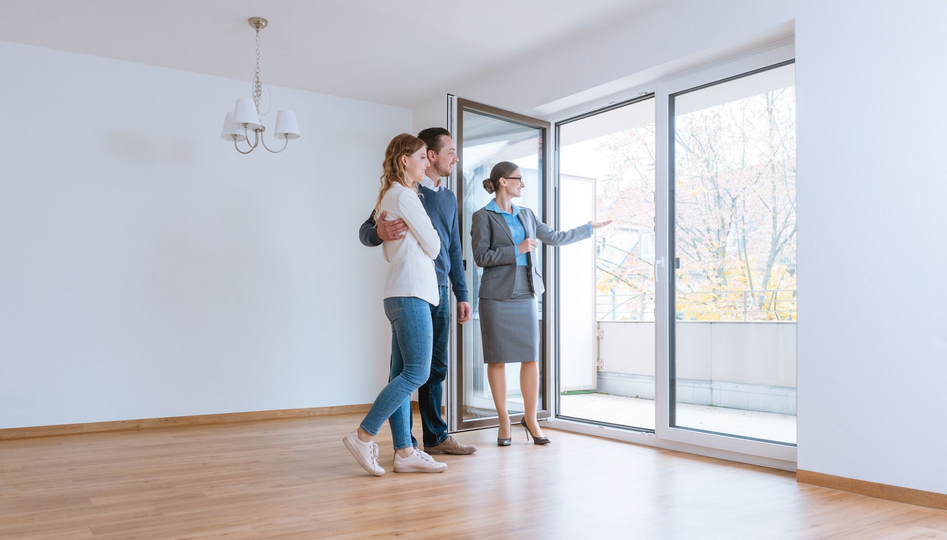 A man and a woman are looking out of a window