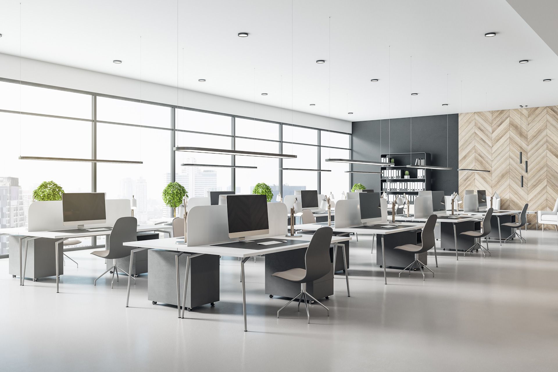 A row of office cubicles with computers and chairs