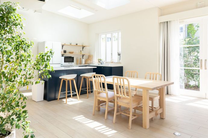 A kitchen and dining area with a table and chairs