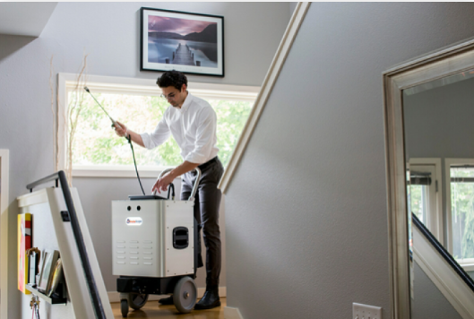 A person holding a smart home app on their phone