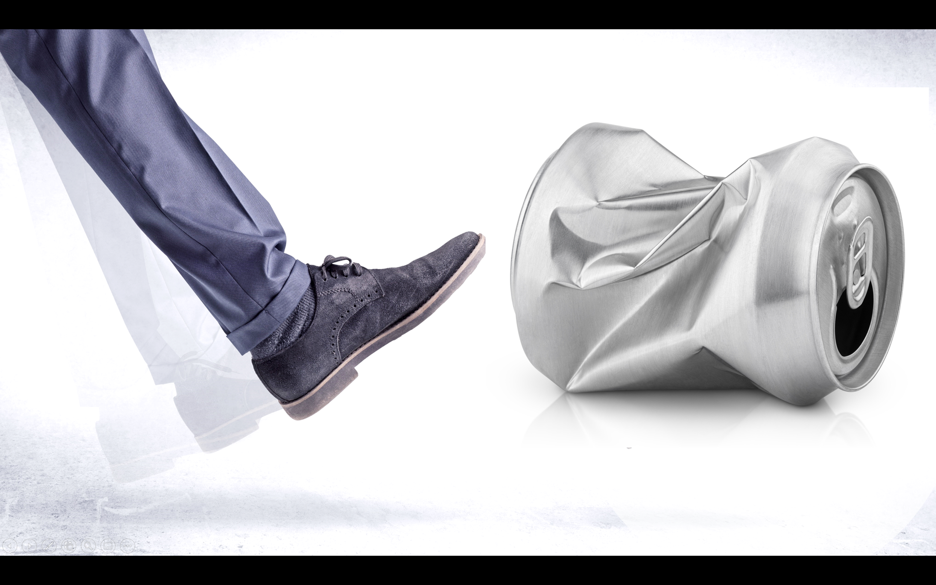 A person is kicking a crushed can of soda.