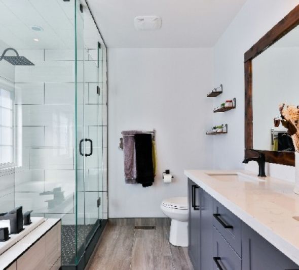 A bathroom with a toilet a sink and a mirror