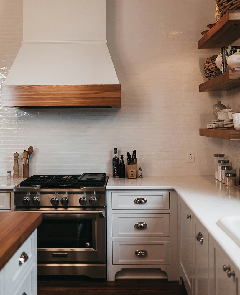 A kitchen with stainless steel appliances and white cabinets