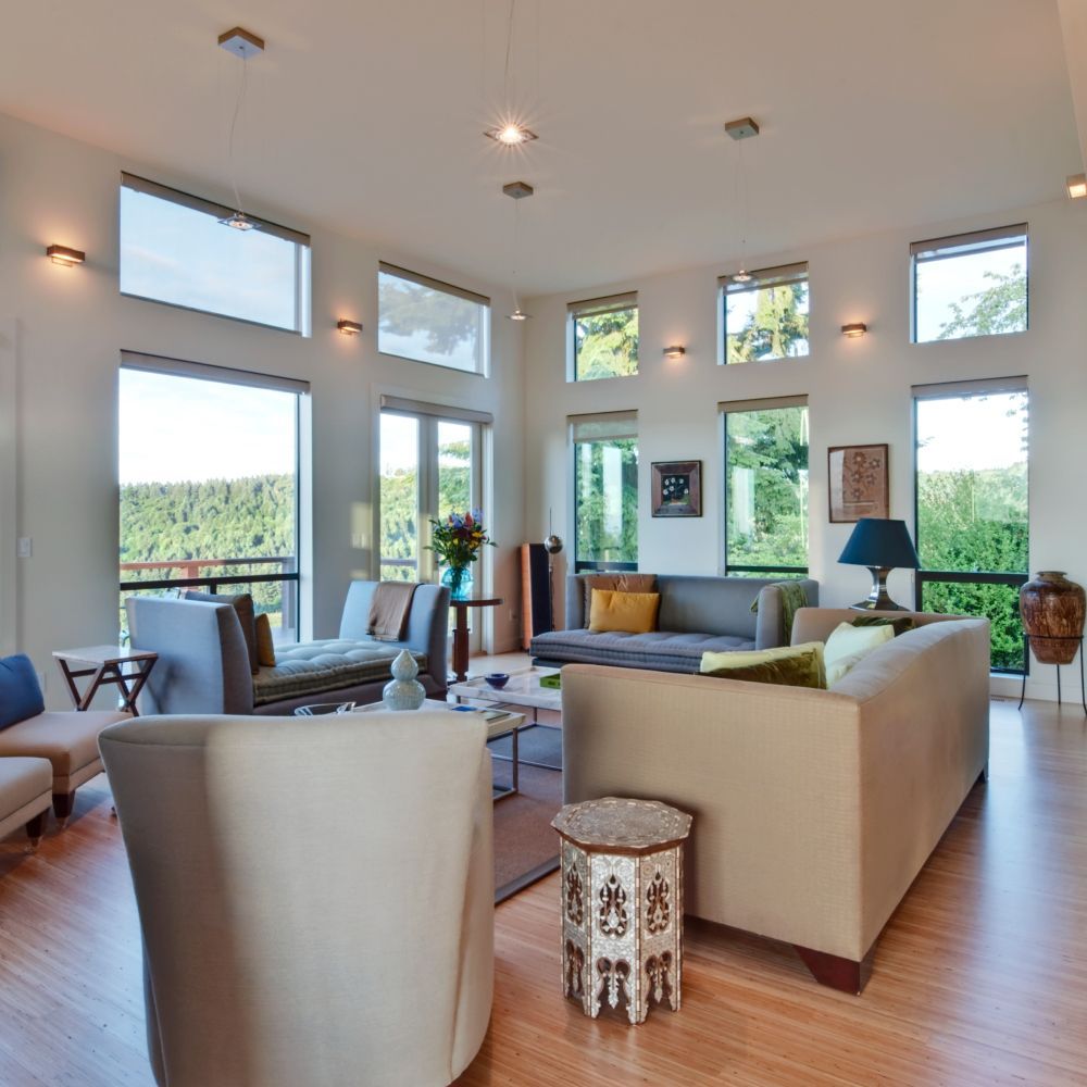 A living room with a lot of windows and furniture