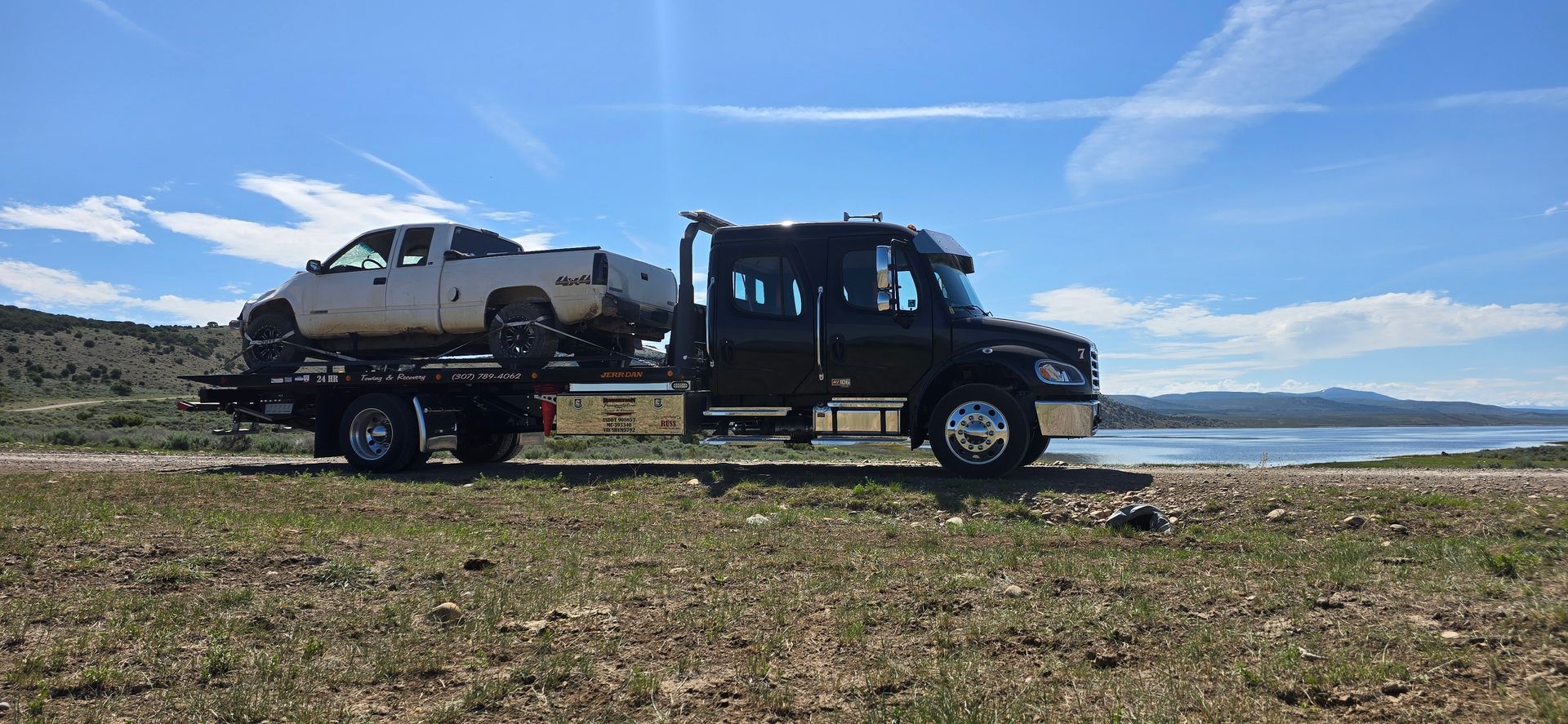 A tow truck is parked in a parking lot with snow — Evanston, WY — Robertson Transportation Inc. Towing and Recovery