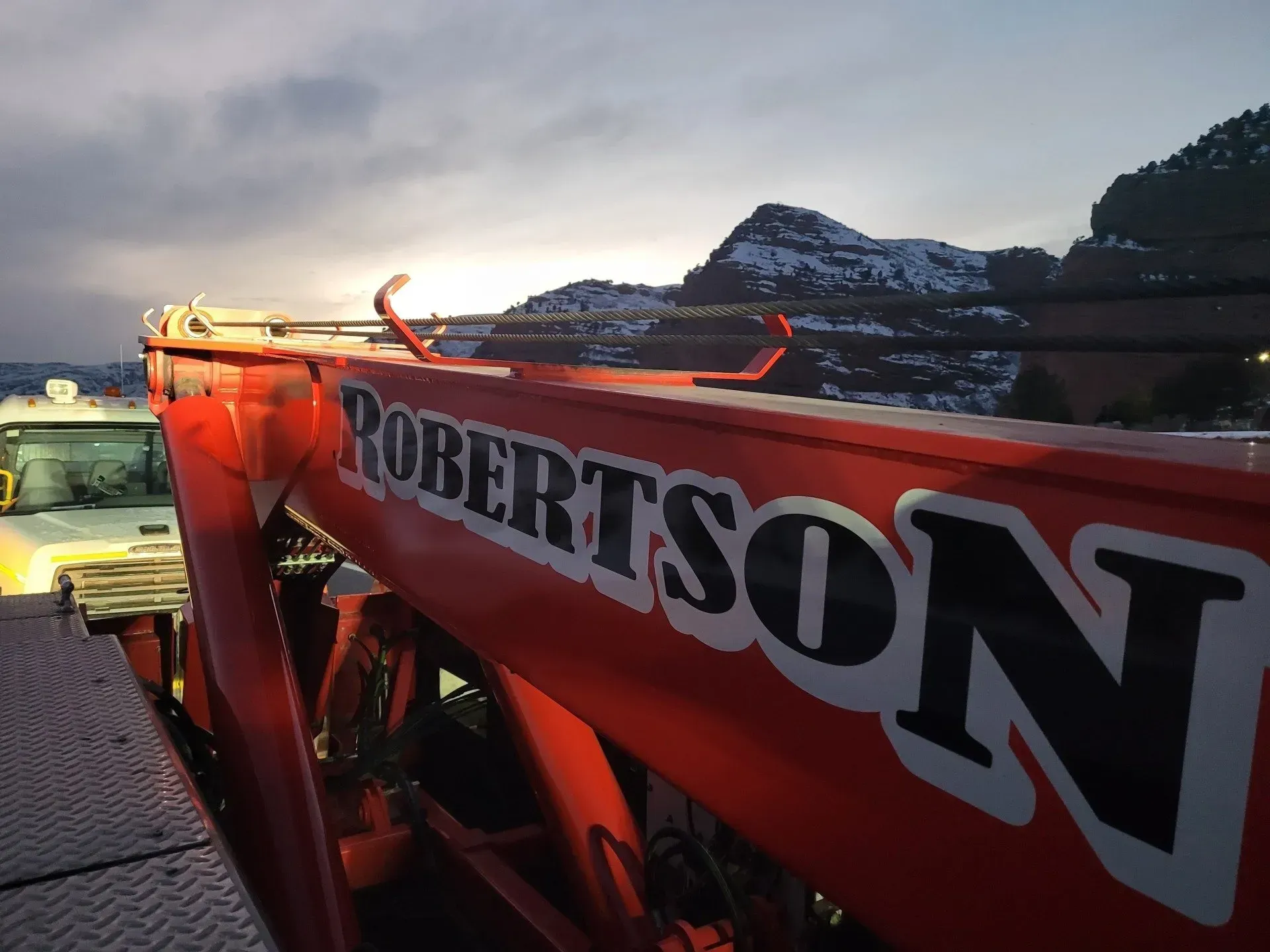 The word robertson is on a red object — Evanston, WY — Robertson Transportation Inc. Towing and Recovery