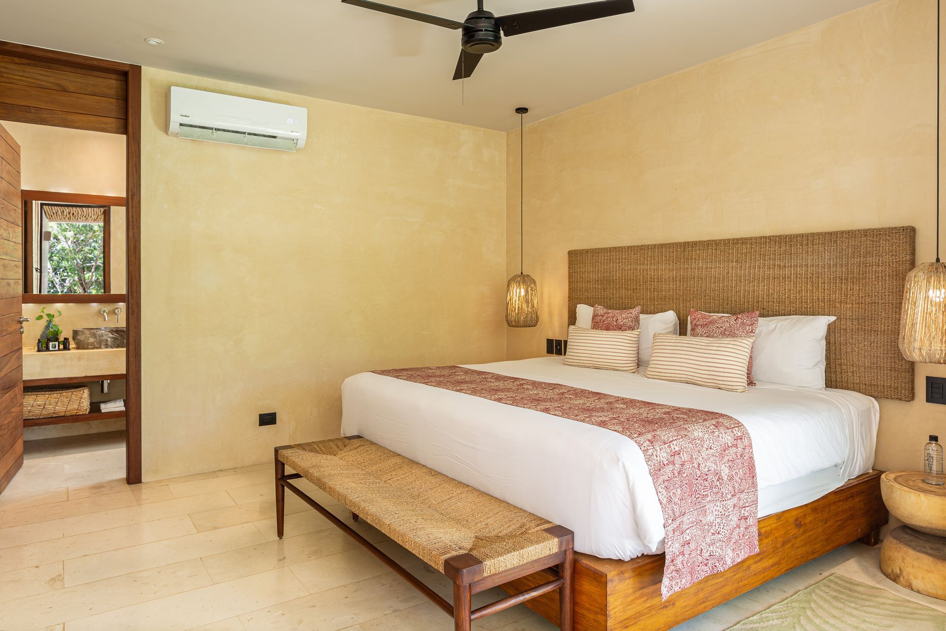 A bedroom with a king size bed and a ceiling fan.