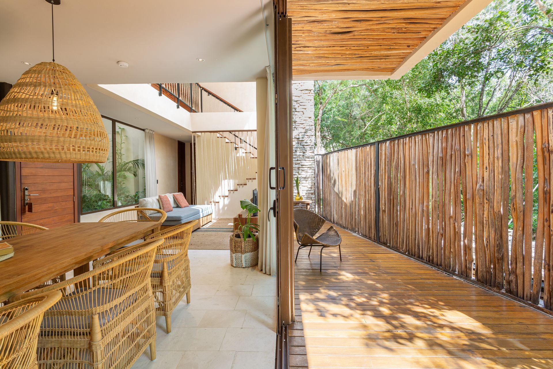 There is a wooden fence between the living room and the dining room.