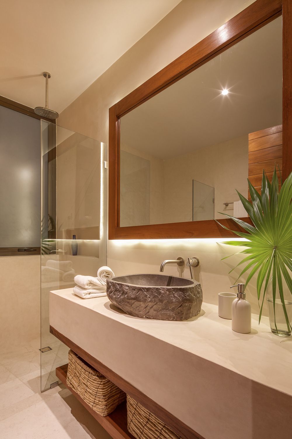 A bathroom with a sink and a large mirror.