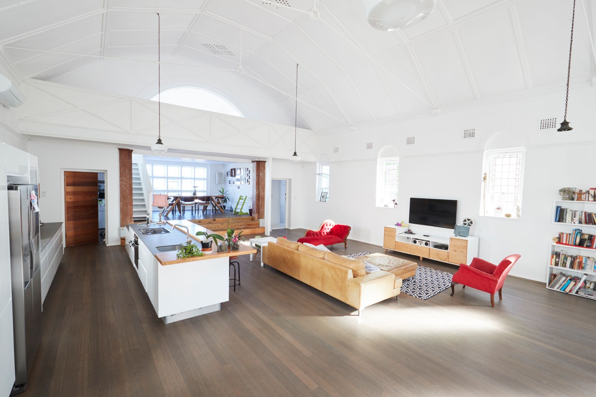 Custom Kitchen Renovation - A large living room with a couch , chairs , and a television.