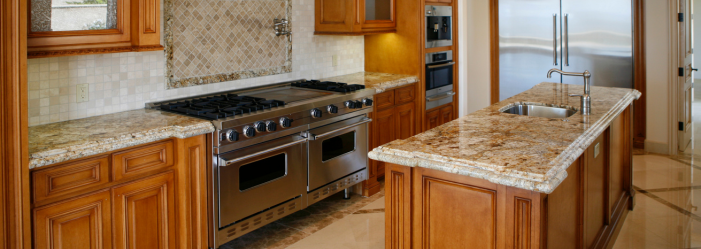 Kitchen with Stainless Steel Double oven, white backsplash, quartz countertops, wood cabinets