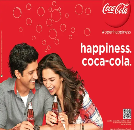 An advertisement for coca-cola shows a man and a woman holding coca-cola bottles