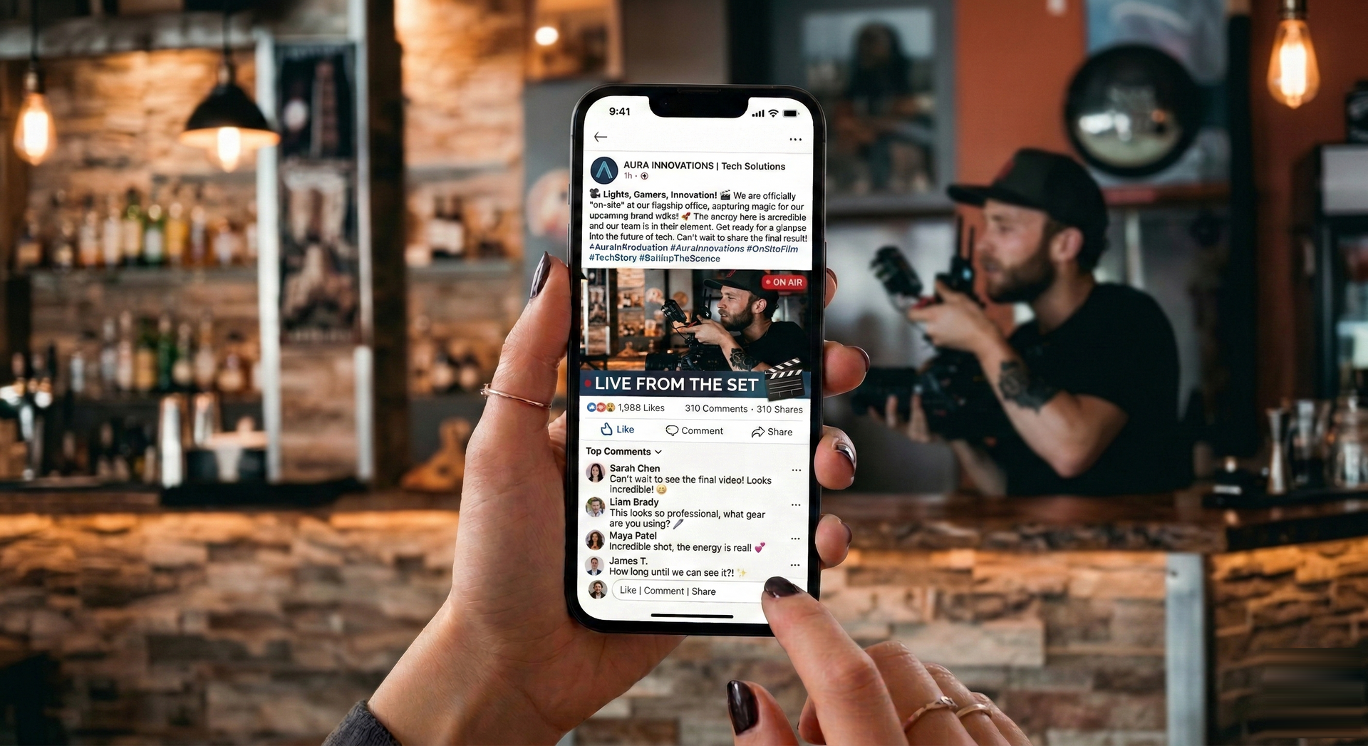 A person holds a smartphone displaying a social media feed, with a blurred bar setting in the background.