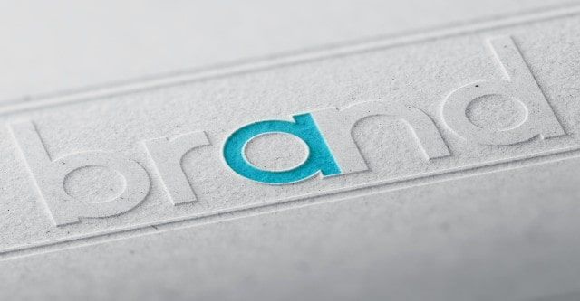 The word brand is embossed on a piece of paper.