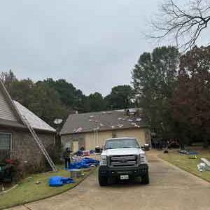 A white truck is parked in front of a house.