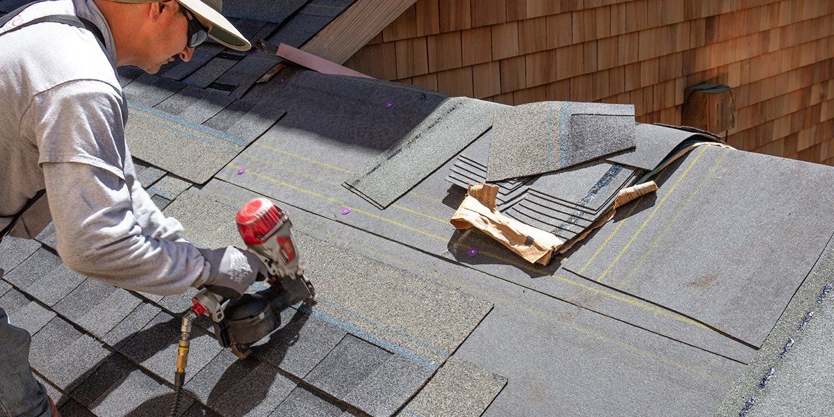 Worker Installing New Shingles — Jacksonville, FL — Triton Roofing and Restoration Worker Installing New Shingles — Jacksonville, FL — Triton Roofing and Restoration