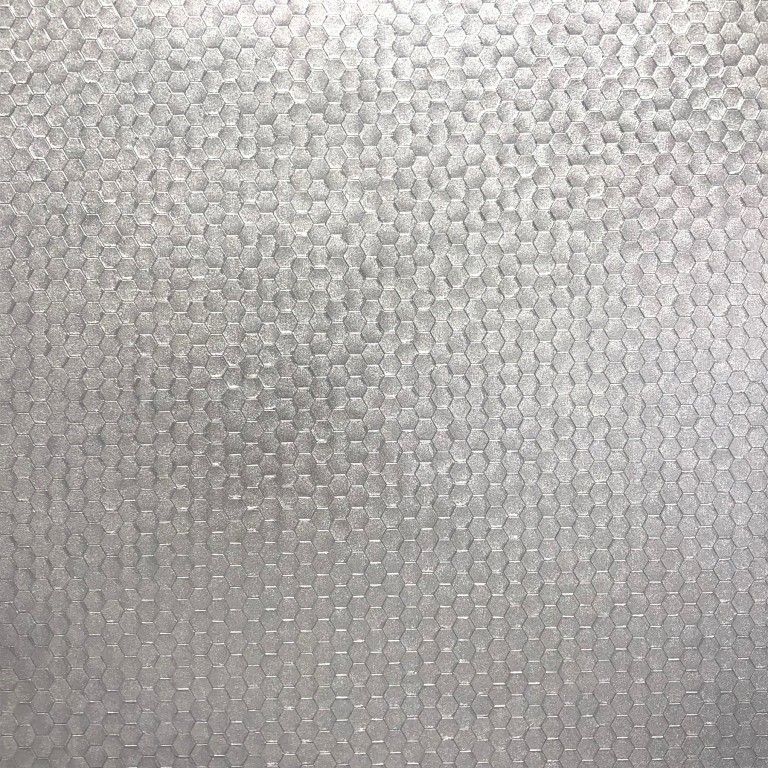 Close-up of a light gray textured surface with a subtle pebbled pattern