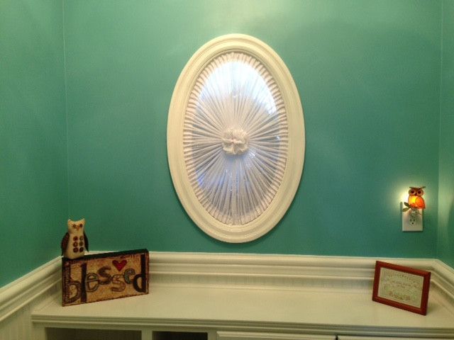 Teal wall with oval window and owls
