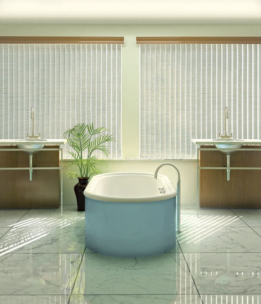 Bathroom with blue tub, two sinks, marble floor, and blinds filtering sunlight.