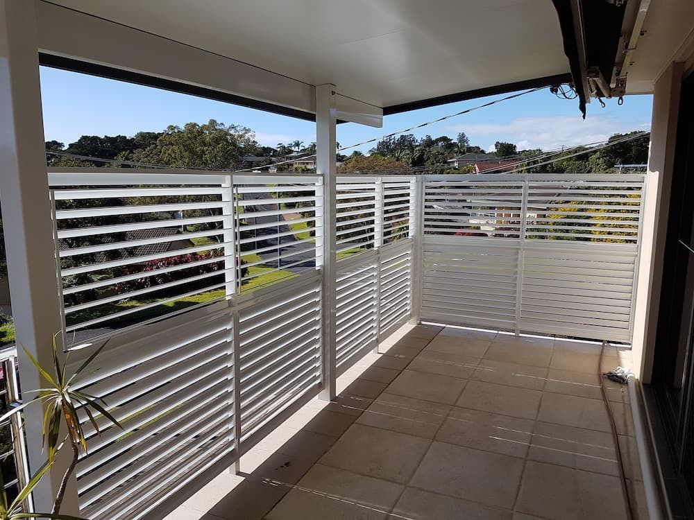 A Balcony With A White Railing And A View Of A City — Summerland Screens & Awnings In Ballina, NSW