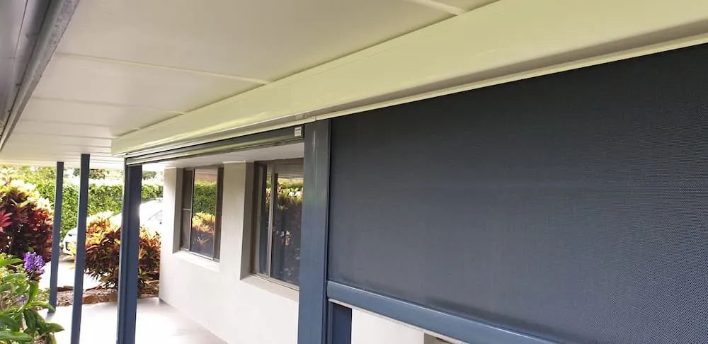 A White House With A Black Awning On The Side Of It — Summerland Screens & Awnings In Ballina, NSW