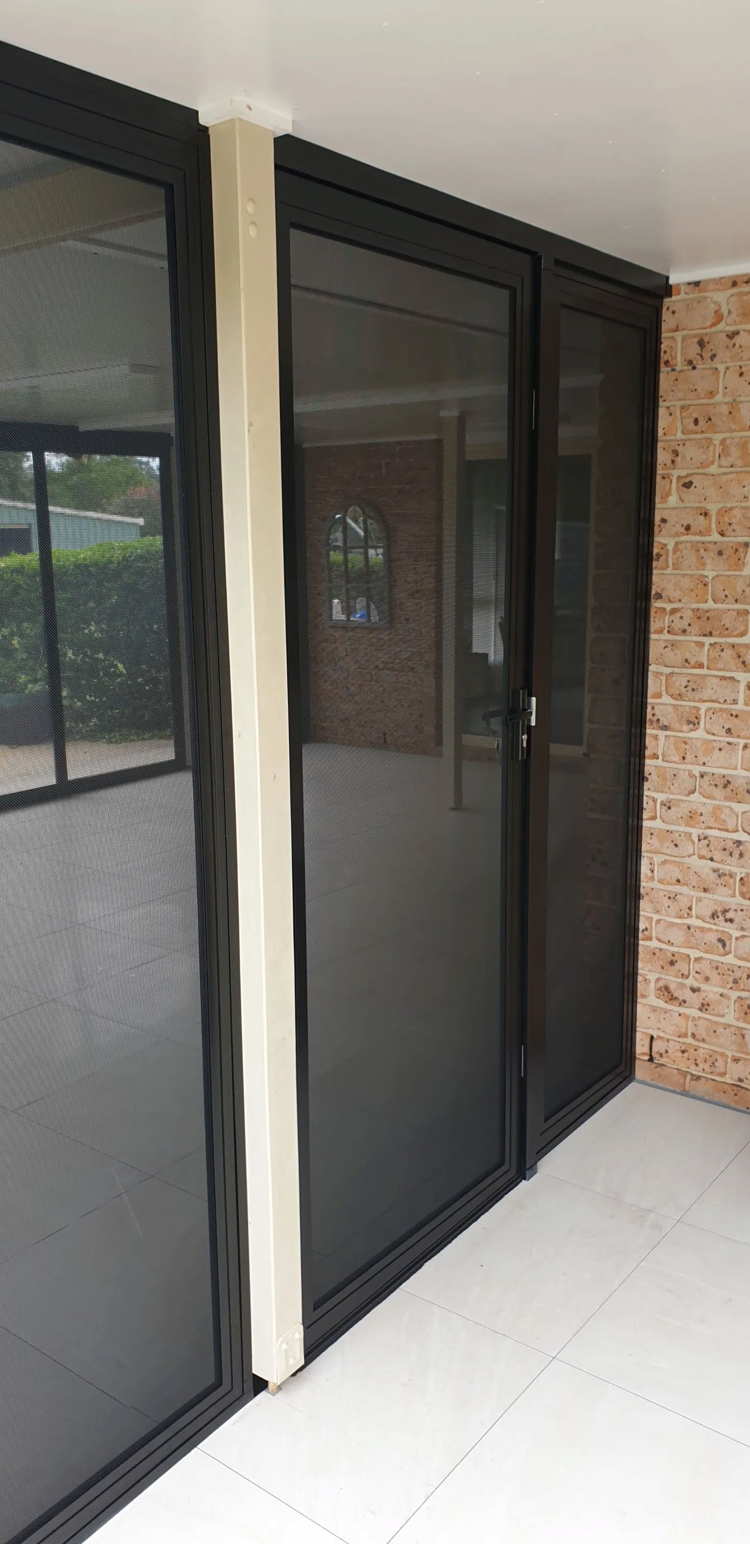 A Room With A Lot Of Windows And A Brick Wall — Summerland Screens & Awnings In Ballina, NSW