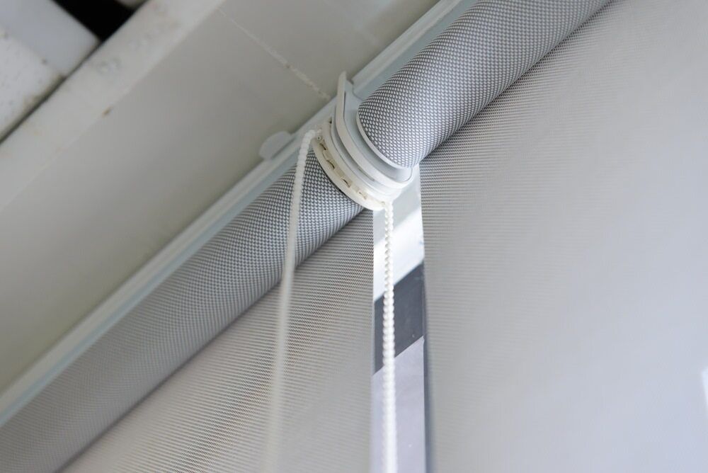 A Close Up Of A Roller Blind Hanging From The Ceiling — Summerland Screens & Awnings In Suffolk Park, NSW