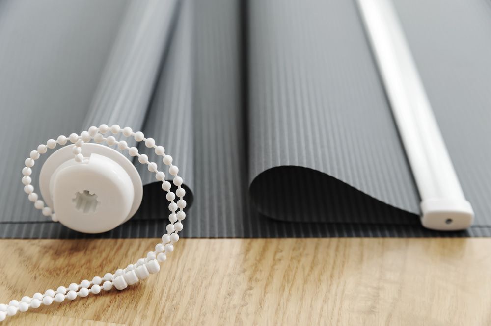 A Close Up Of A Roller Blind On A Wooden Floor — Summerland Screens & Awnings In Alstonville, NSW