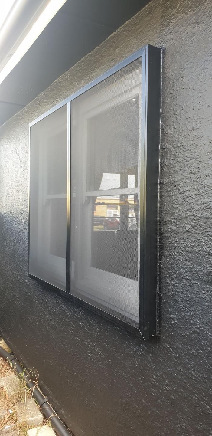 A Window With A Screen On It Is On The Side Of A Building — Summerland Screens & Awnings In Ballina, NSW