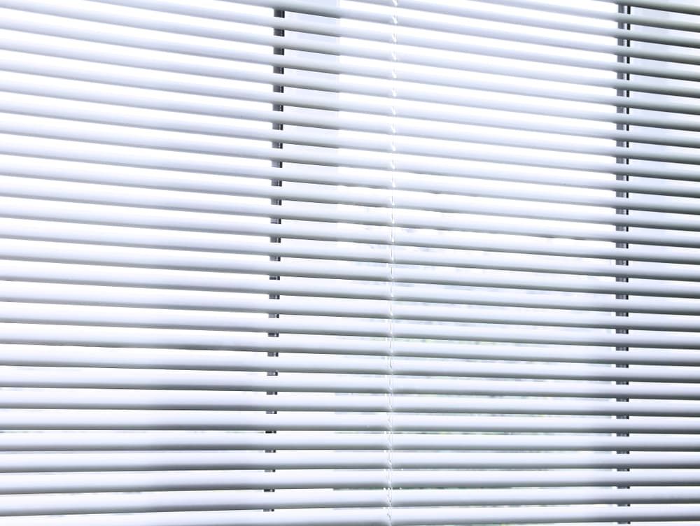A Close Up Of A White Blind On A Window — Summerland Screens & Awnings In Evans Head, NSW