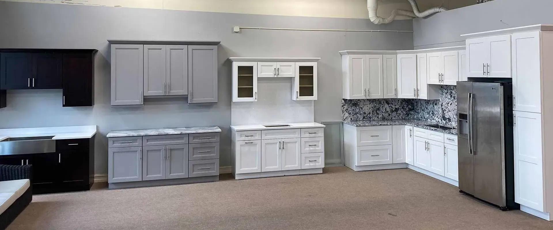 There are many different types of cabinets in this kitchen showroom.