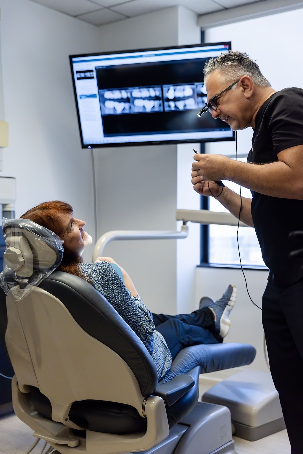 Dentist examining a patient in a dental chair during a checkup