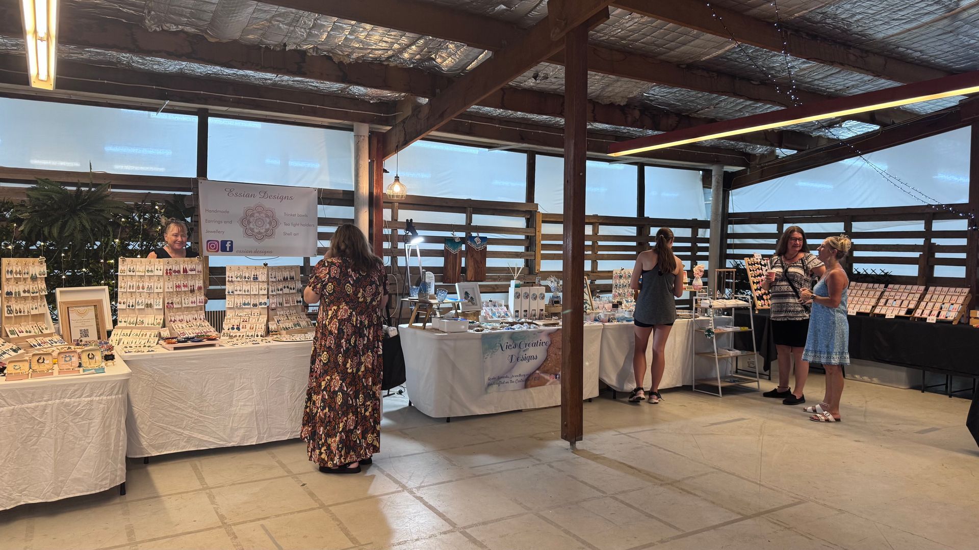 An indoor craft fair with jewelry displays and people browsing — Rustique on the Coast In Ourimbah, NSW