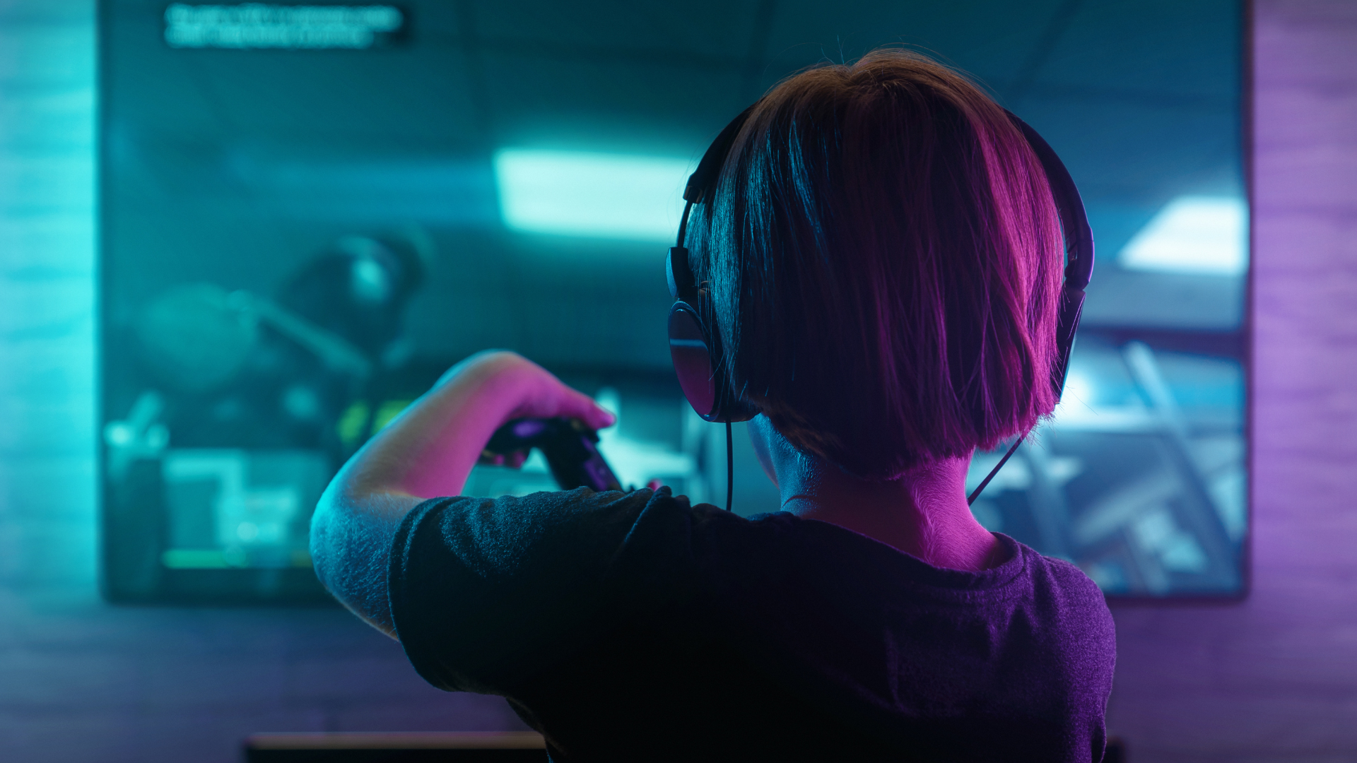A person wearing headphones is playing a video game on a television.