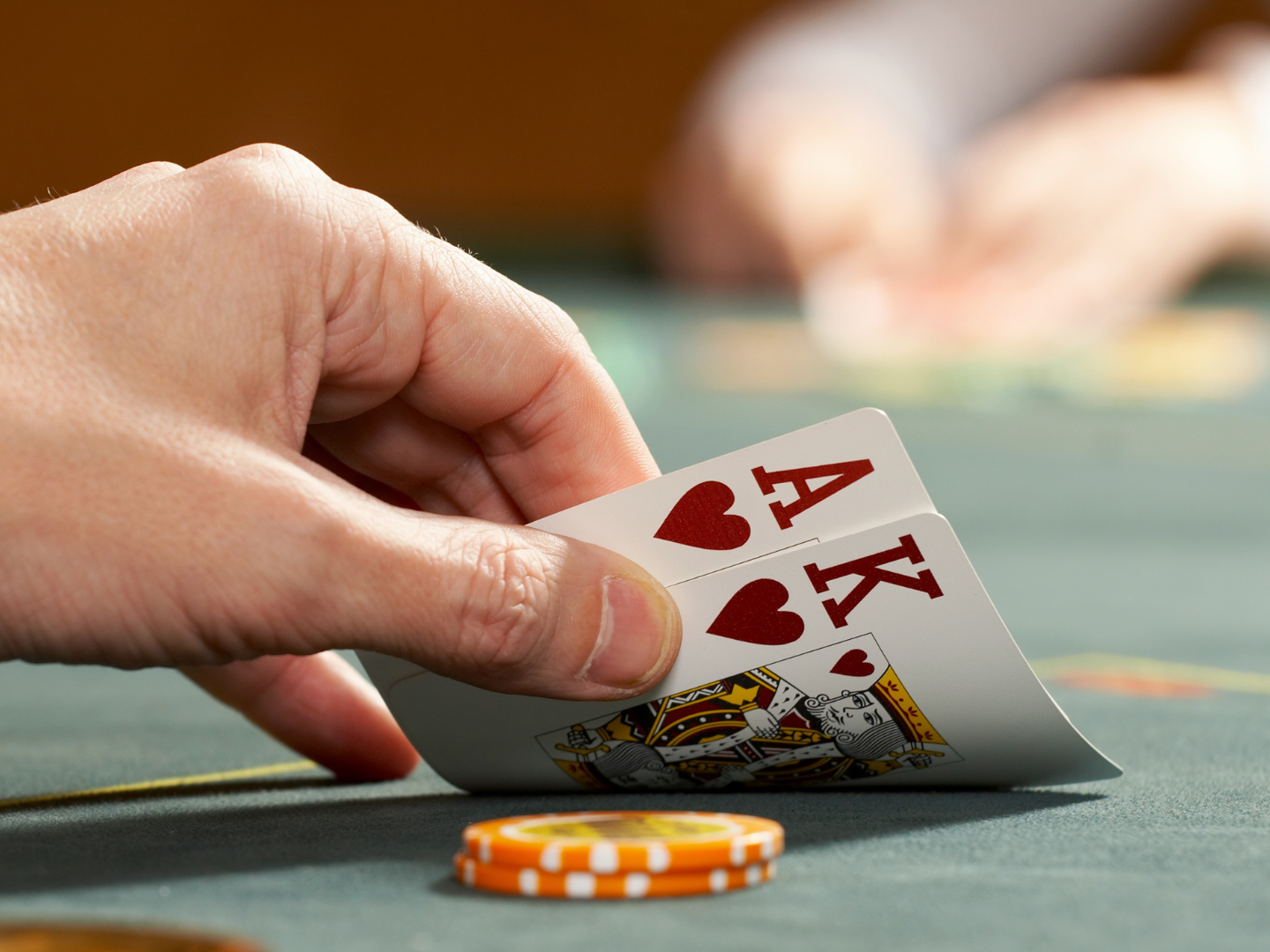 A person is holding two aces in their hand