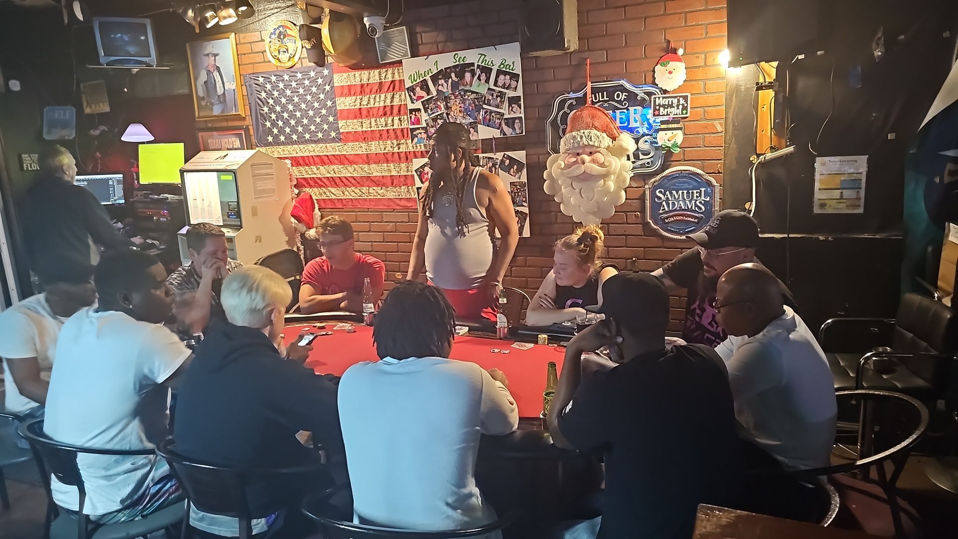 Live music performance in a dim bar, with patrons seated at tables facing a singer onstage.