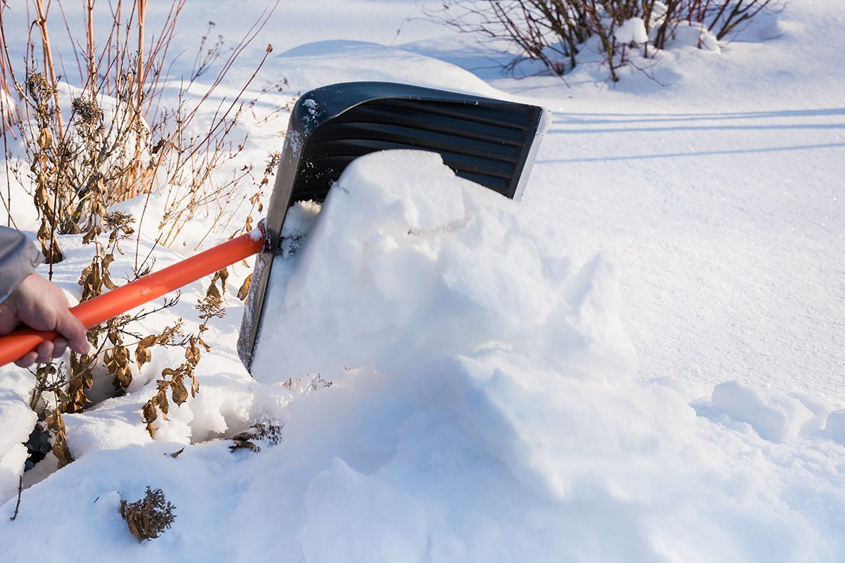 A person is shoveling snow from a pile of snow.