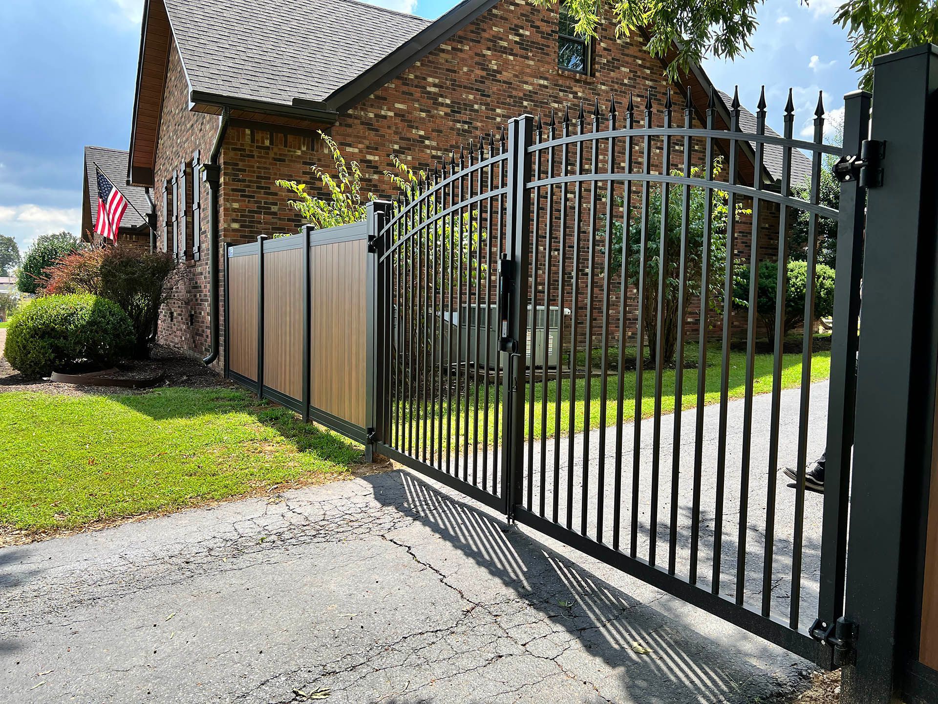 Aluminum installation in Denver, North Carolina featuring tall wood panels for classic style, lasting privacy, and natural curb appeal in residential spaces.