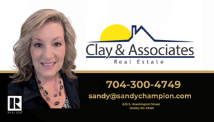 A woman is smiling in front of a clay & associates real estate logo