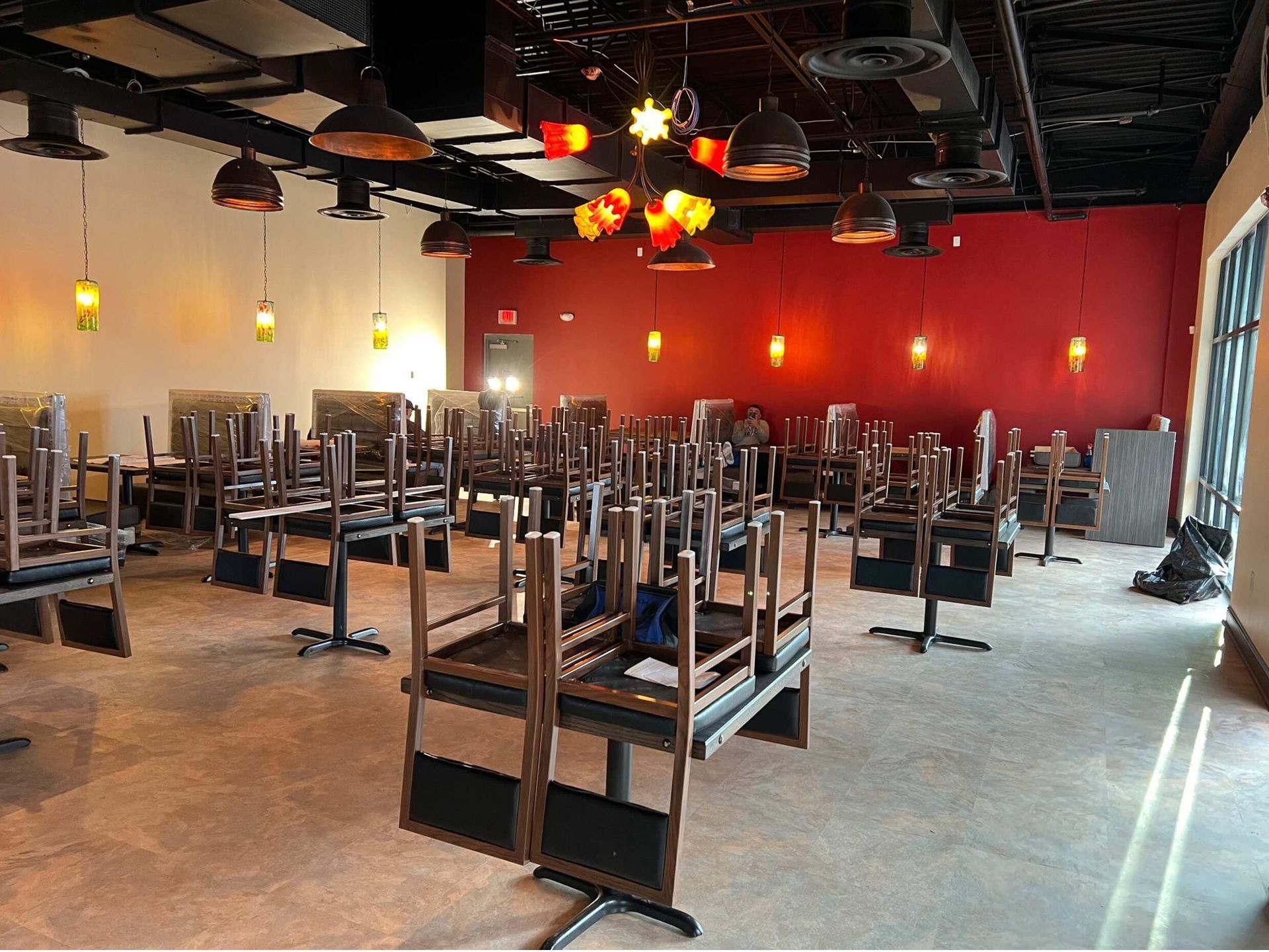 An empty restaurant with tables and chairs stacked on top of each other