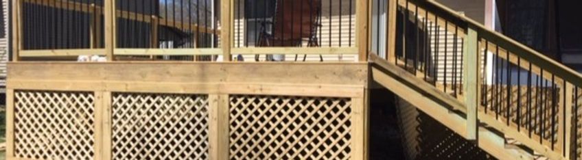 Wooden deck and staircase with lattice skirting in a sunny outdoor setting
