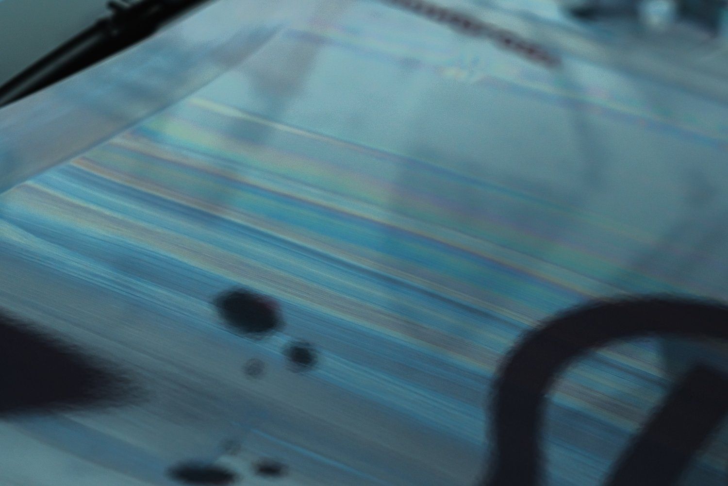 A close up of a blue tile floor with a blurred background.