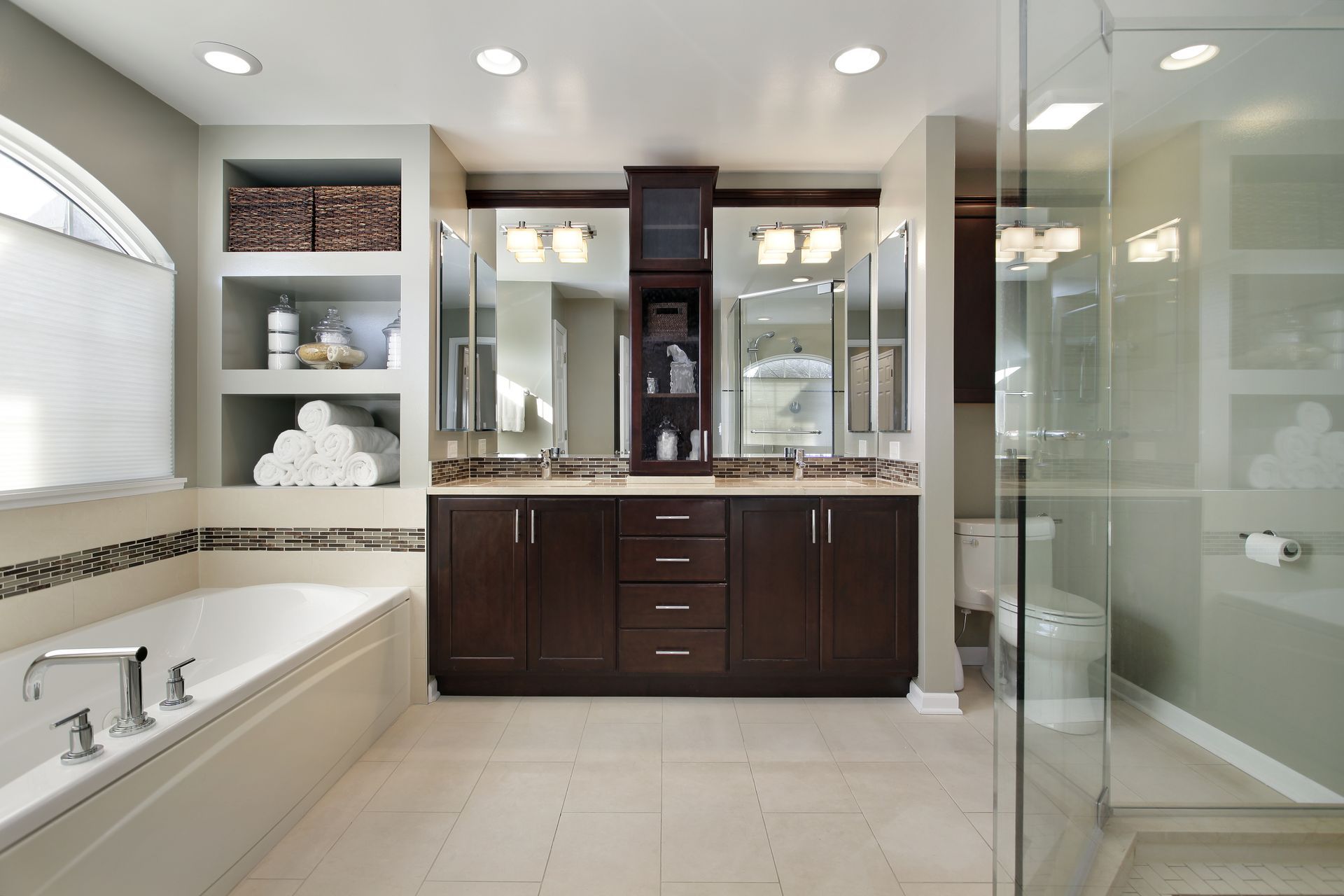 A bathroom with two sinks a tub and a walk in shower