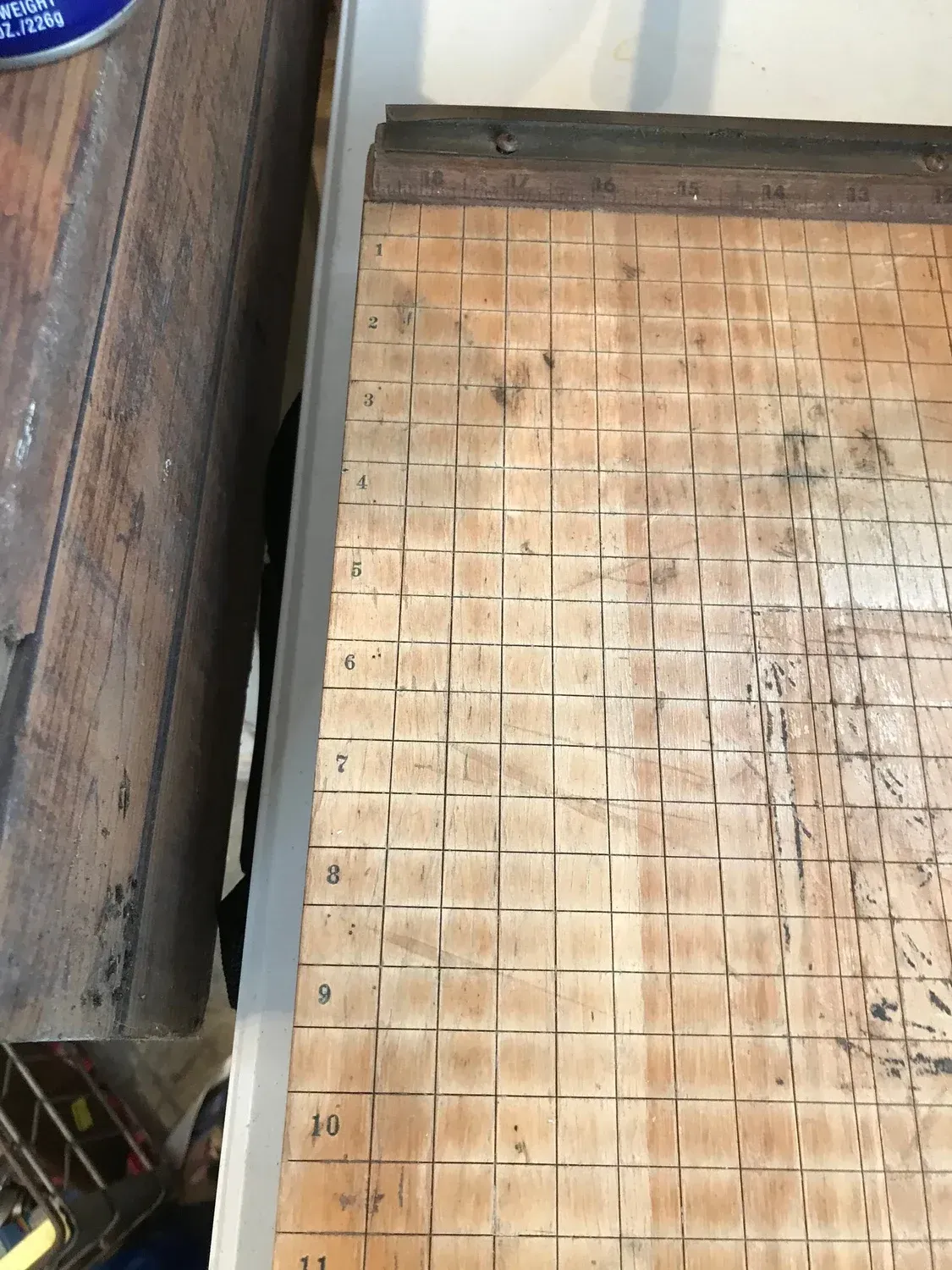 A wooden cutting board with a grid pattern on it