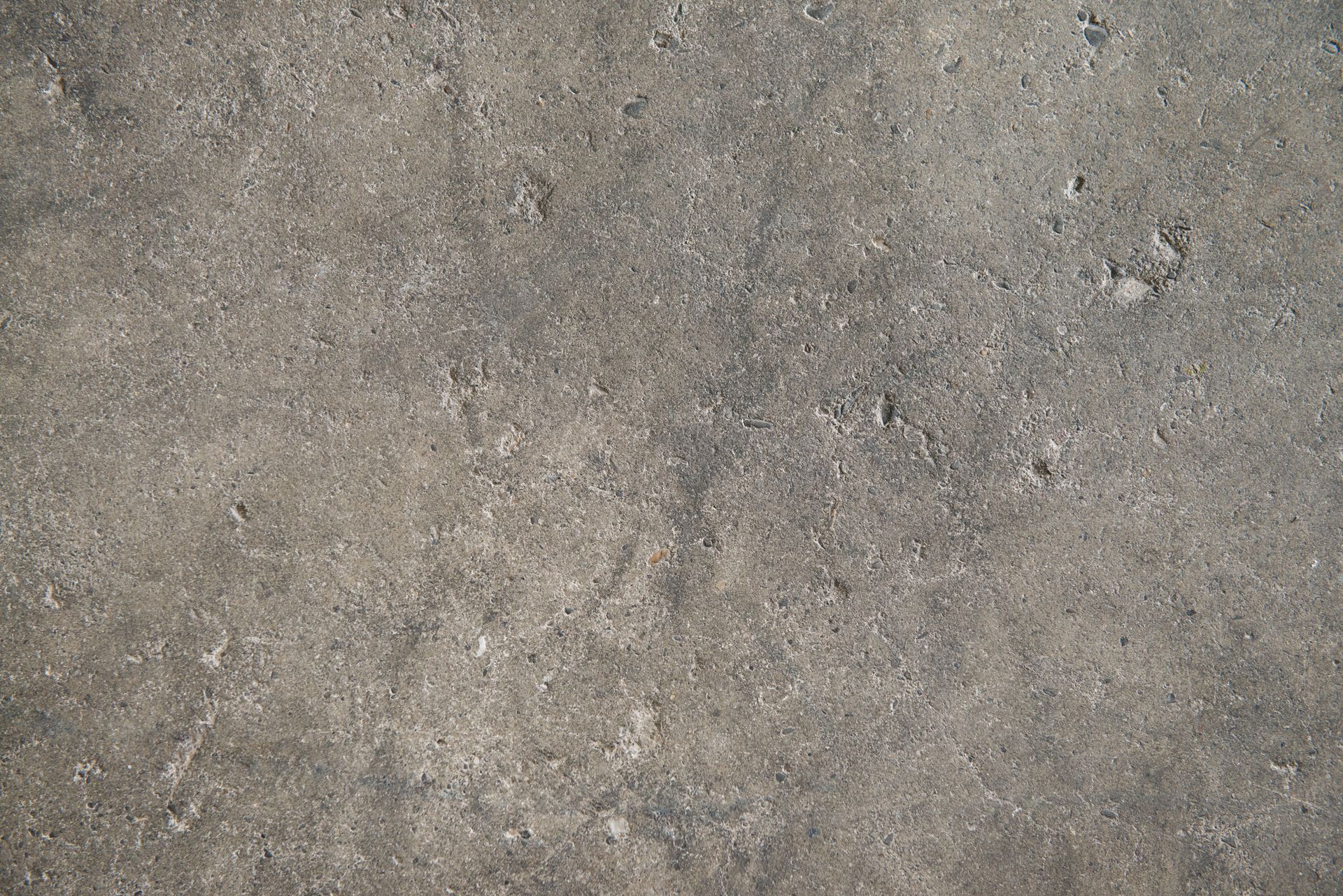 Gray concrete surface with slight texture and small imperfections. Gray concrete surface with slight texture and small imperfections.