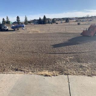 Bulldozer Moving Dirt in Field to Sidewalk  - Elizabeth, CO – NRK Skidsteer
