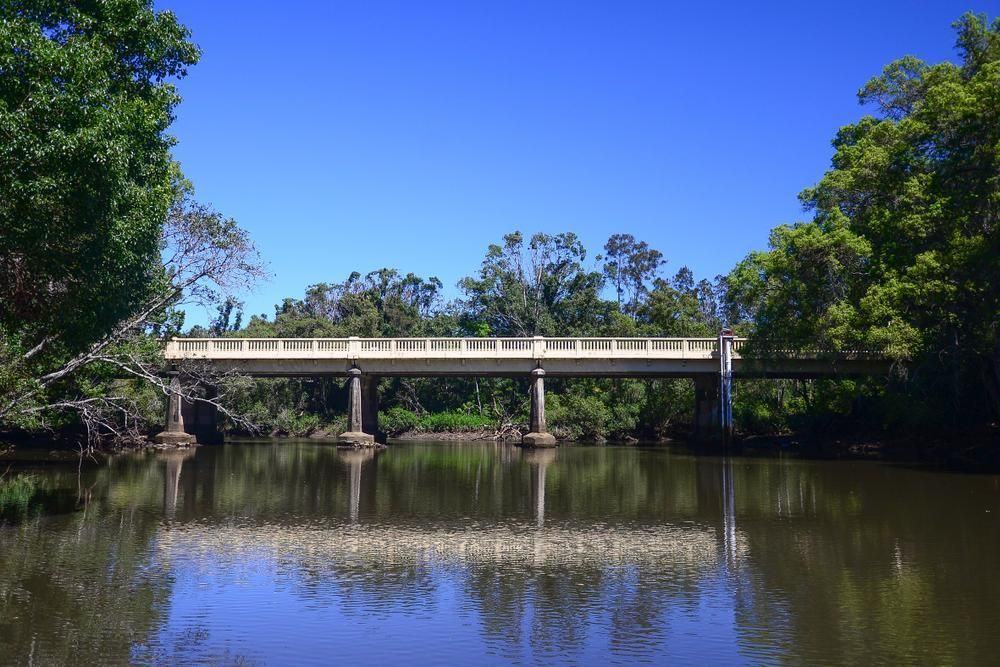 A Bridge Over A River With Trees In The Background — Donnelly Painting In Brunswick Heads, NSW