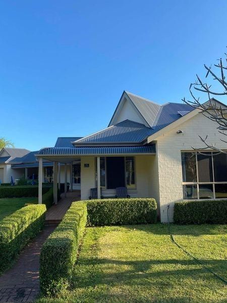 A White House With A Blue Roof And A Lush Green Yard — Donnelly Painting In Wollongbar, NSW